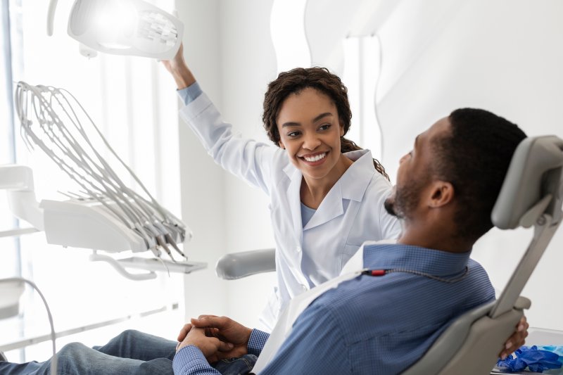 Patient smiling at the dentist after getting same-day dental crowns